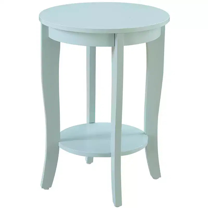 Table d'appoint ronde HomeStock Belmont avec étagère inférieure, pieds incurvés et finition lisse, idéale pour les coins de salon ou de chambre à coucher.